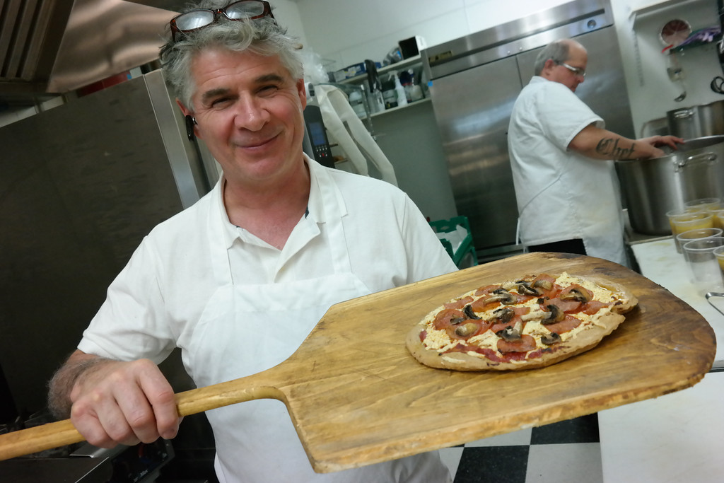 Richard Bourdon stretching dough at the cafe